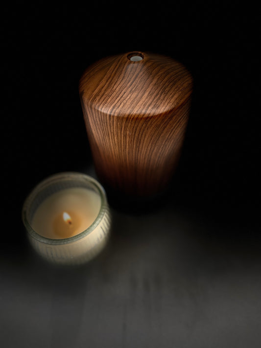 Aromatherapy diffuser with essential oils and calming candles.