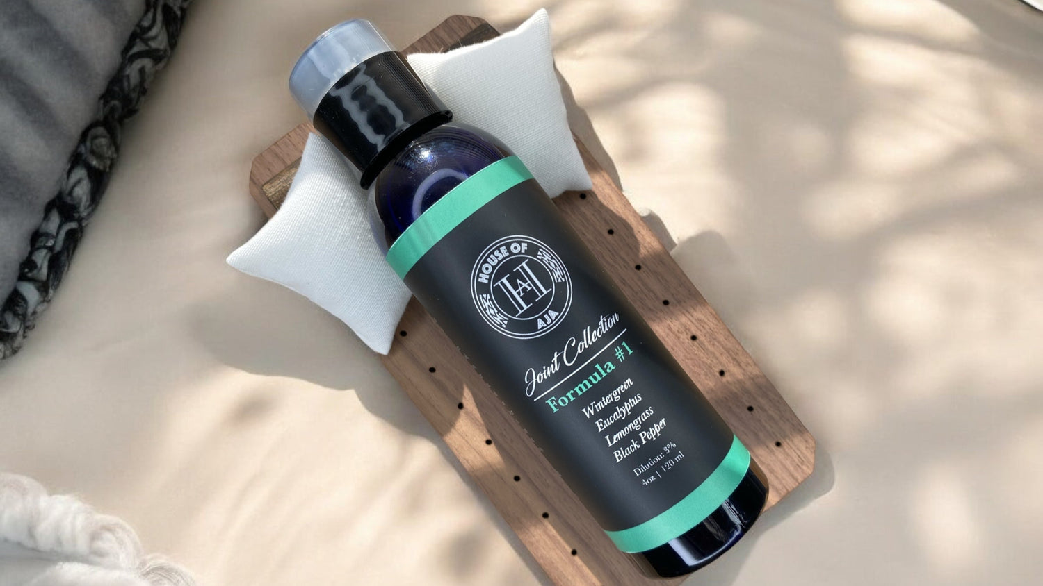 House of Aja formula #1 massage oil bottle featuring wintergreen,
and eucalyptus aromatherapy oils for massage therapy