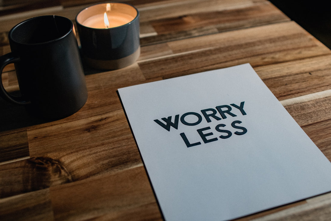 Image of a candle with the words 'Worry Less' written on it, symbolizing relaxation and stress relief