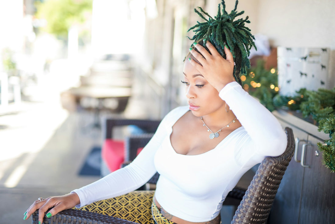 African American woman with vibrant, healthy dreadlocks, showcasing the transformative effects of House of Aja's Essential Oil Blend for natural dreadlock care.