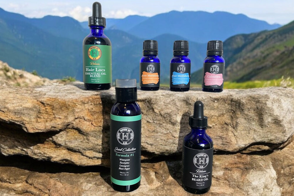 House of Aja essential oils and wellness products displayed on a mountain rock, showcasing nature-inspired aromatherapy solutions for stress relief, relaxation, and holistic wellness.
